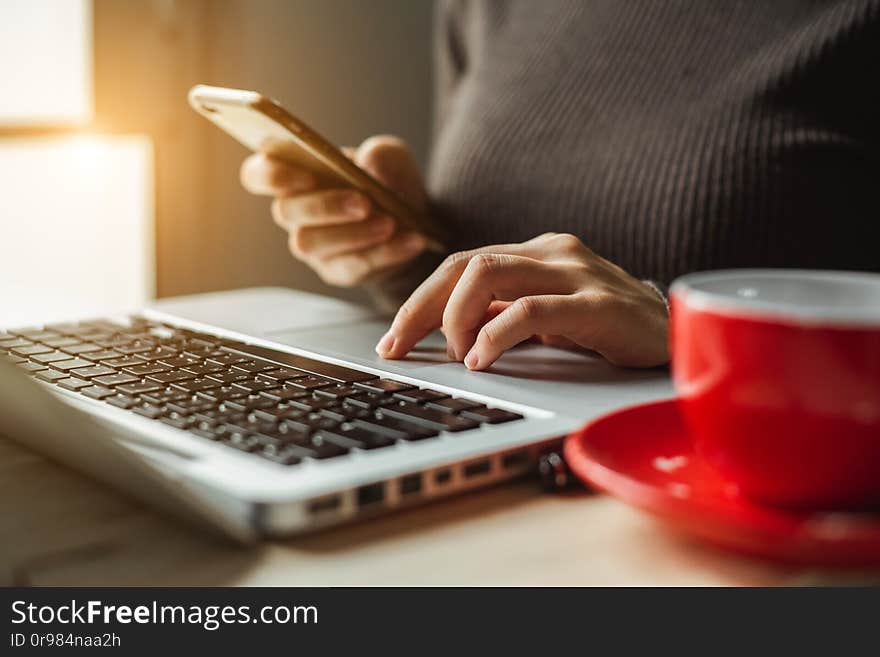 Businesswoman hand using smart phone, tablet payments and holding credit card online shopping, omni channel, digital tablet docking keyboard computer at office in sun light. Businesswoman hand using smart phone, tablet payments and holding credit card online shopping, omni channel, digital tablet docking keyboard computer at office in sun light