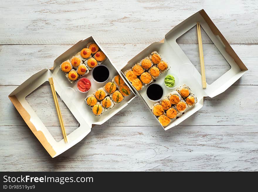 Two Sushi Set In A Box On A Wooden Table. Street Food. Top View.