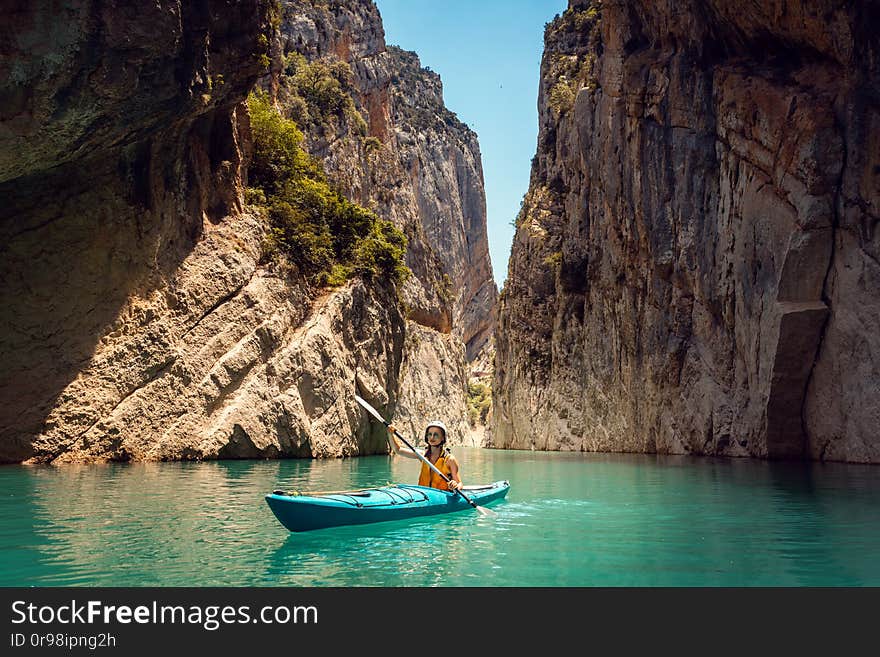 Woman on a kayak in the Pyrenees mountains in Catalonia