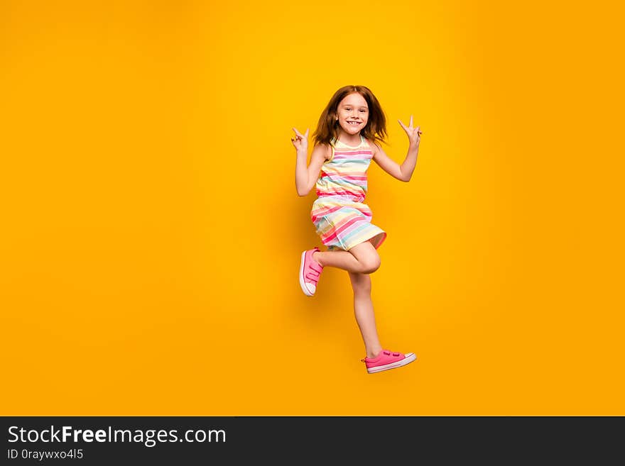 Full Size Photo Of Cheerful Kid Jumping Making V-signs Isolated Over Yellow Background