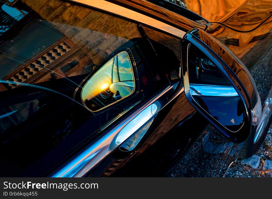 Luxury Car Mirror With Sunset Reflection