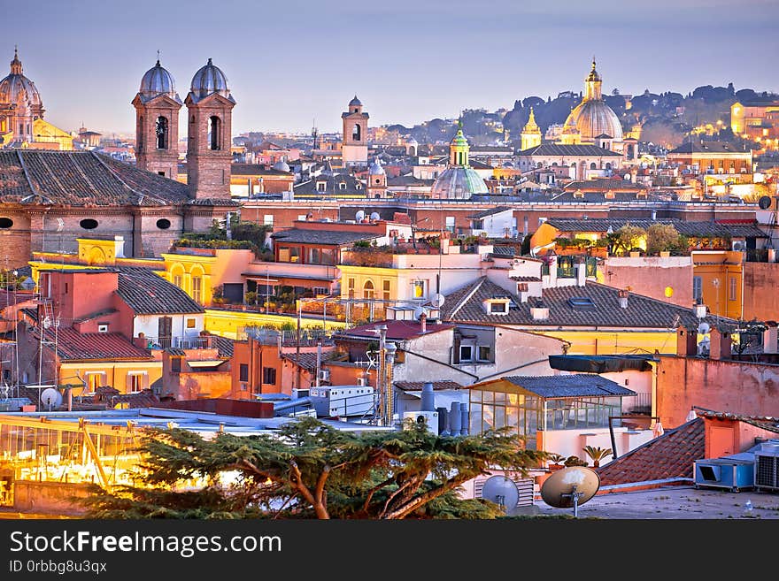 Colorful rooftops of Eternal city of Rome at dusk view, capital of Italy