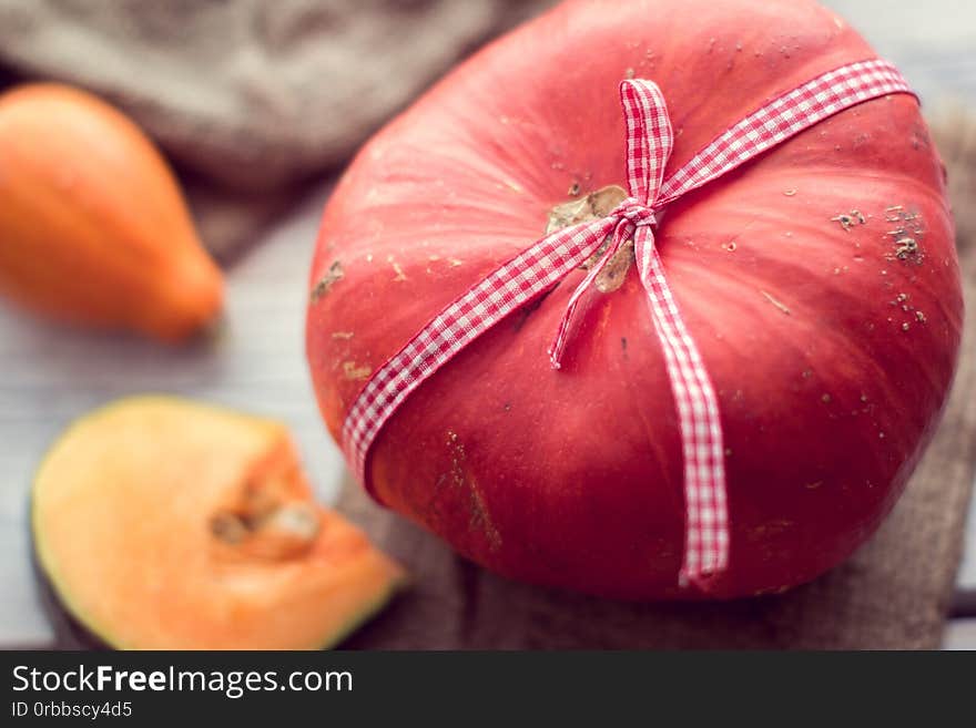 Red pumpkin tied with a ribbon. Red pumpkin tied with a ribbon