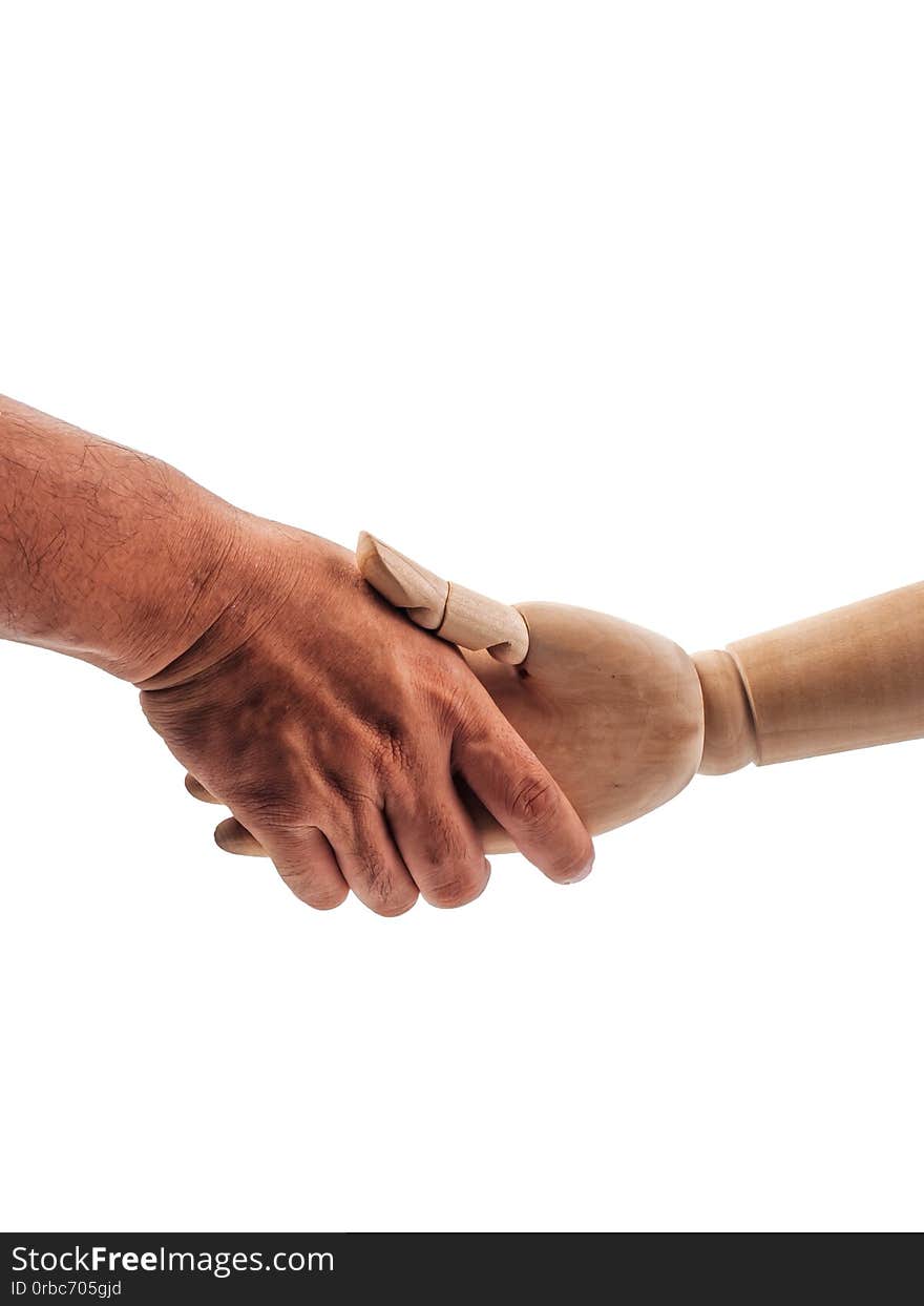 The hands of the wooden doll are holding on to the human hand on white background