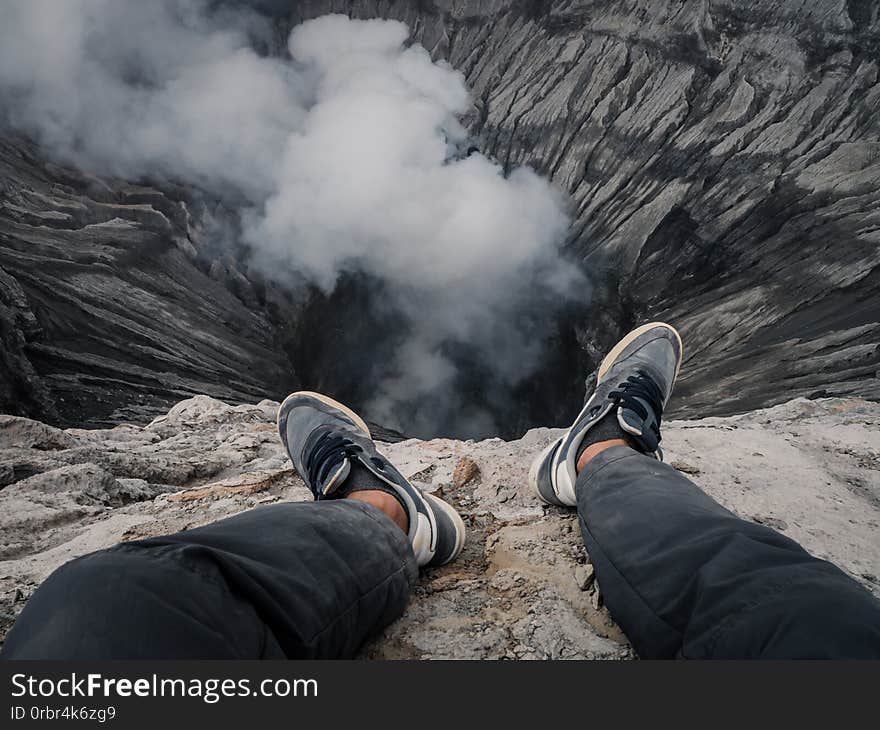 Feet on the edge of a volcano crater