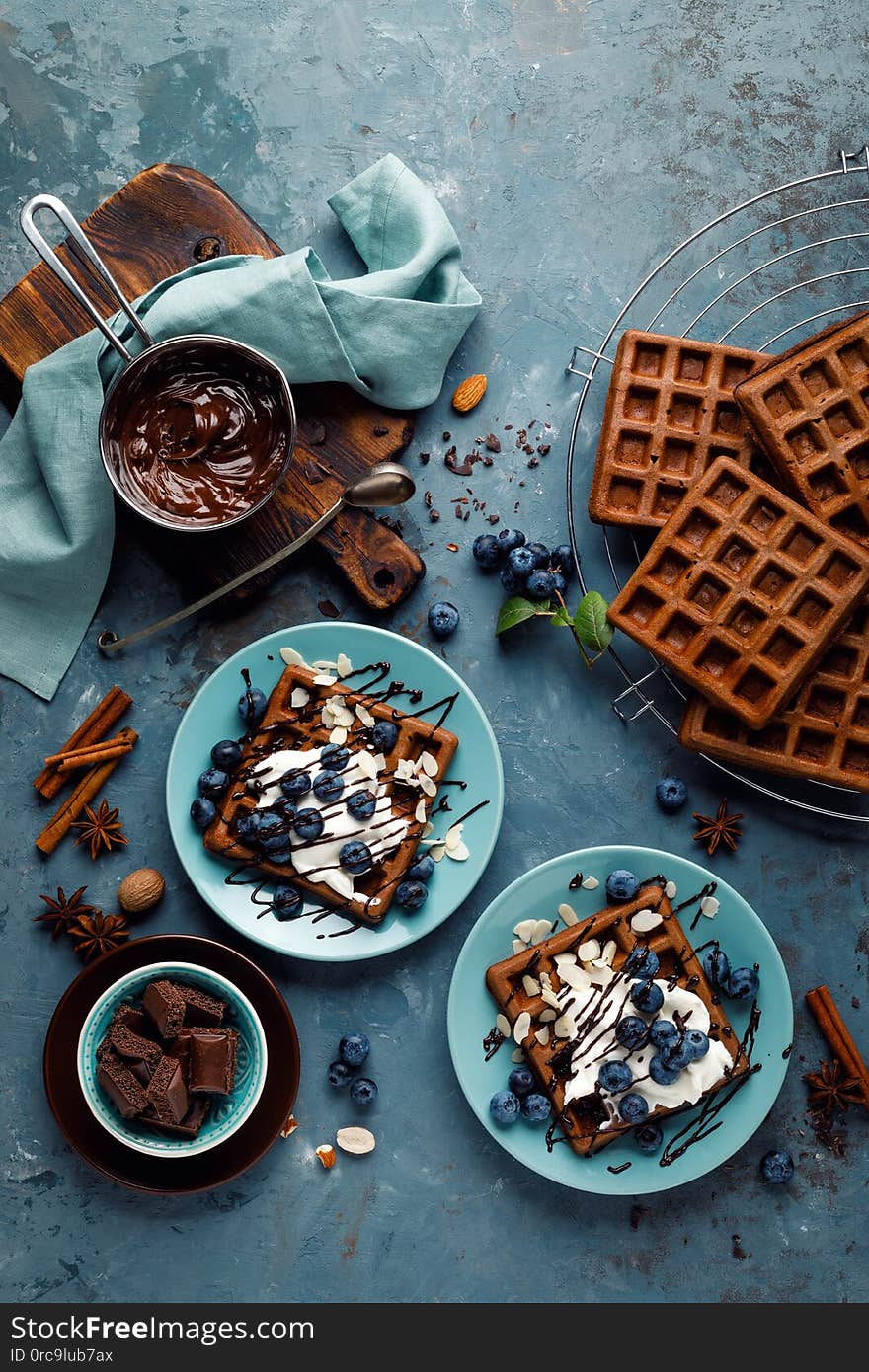 Chocolate Belgian Waffles With Ice Cream And Fresh Blueberry On Blue Background