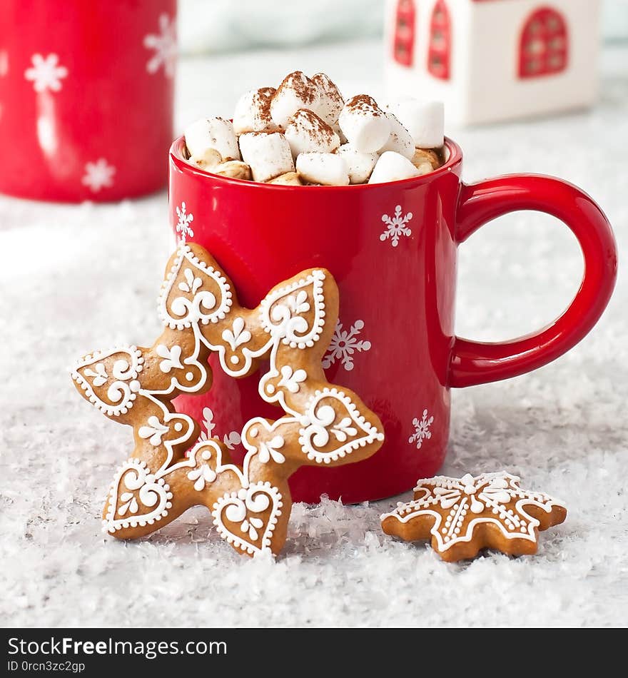 Christmas gingerbread cookies  with hot chocolate and marshmallows on snow background,  selective focus with shallow depth of field. Christmas gingerbread cookies  with hot chocolate and marshmallows on snow background,  selective focus with shallow depth of field