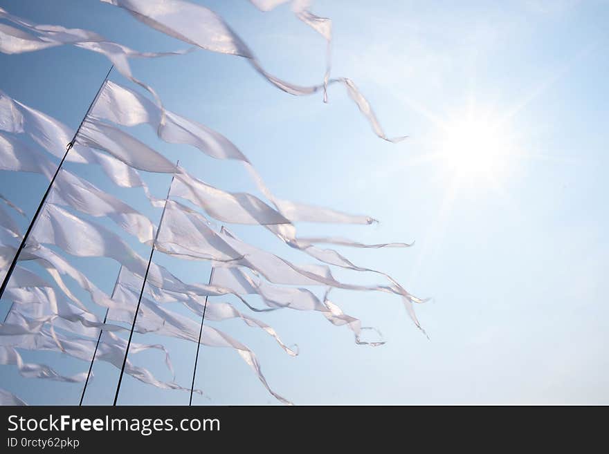 Triangular White Banner Against The Blue Sky