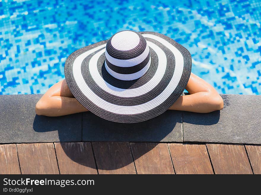 Portrait beautiful young asian woman happy smile relax around swimming pool in hotel resort for leisure travel and vacation