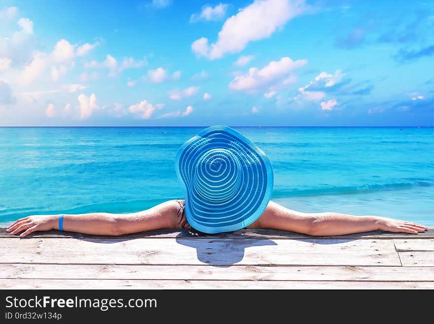 Woman in hat at beautiful Caribbean sea, Mexico