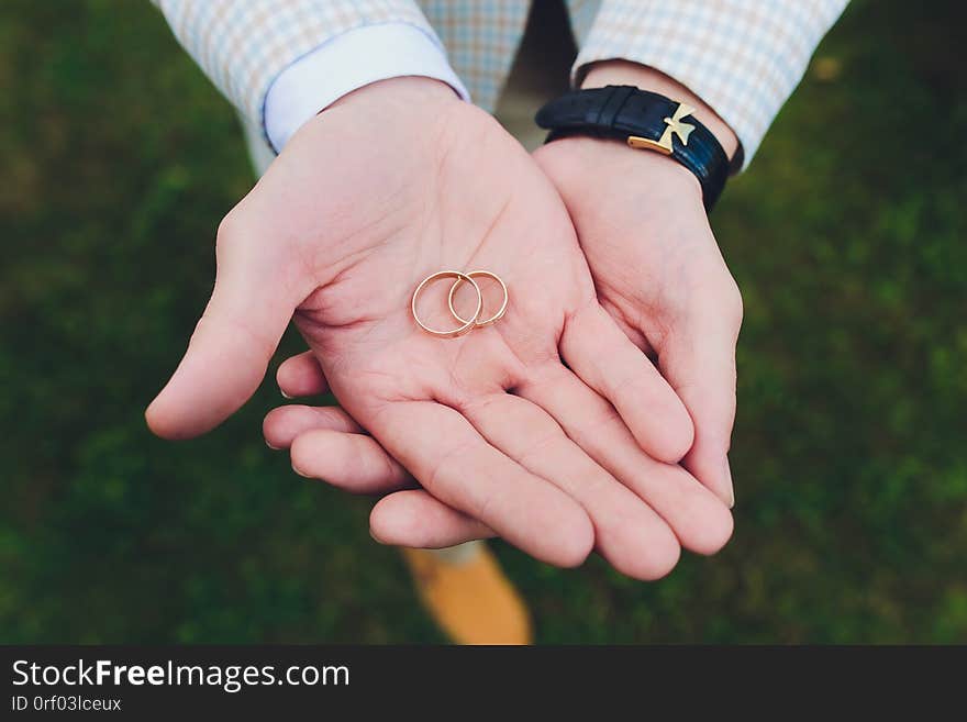 Wedding rings in the hand of the groom.