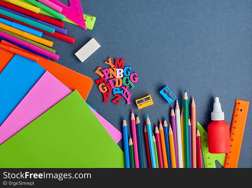 School supplies frame on a dark background