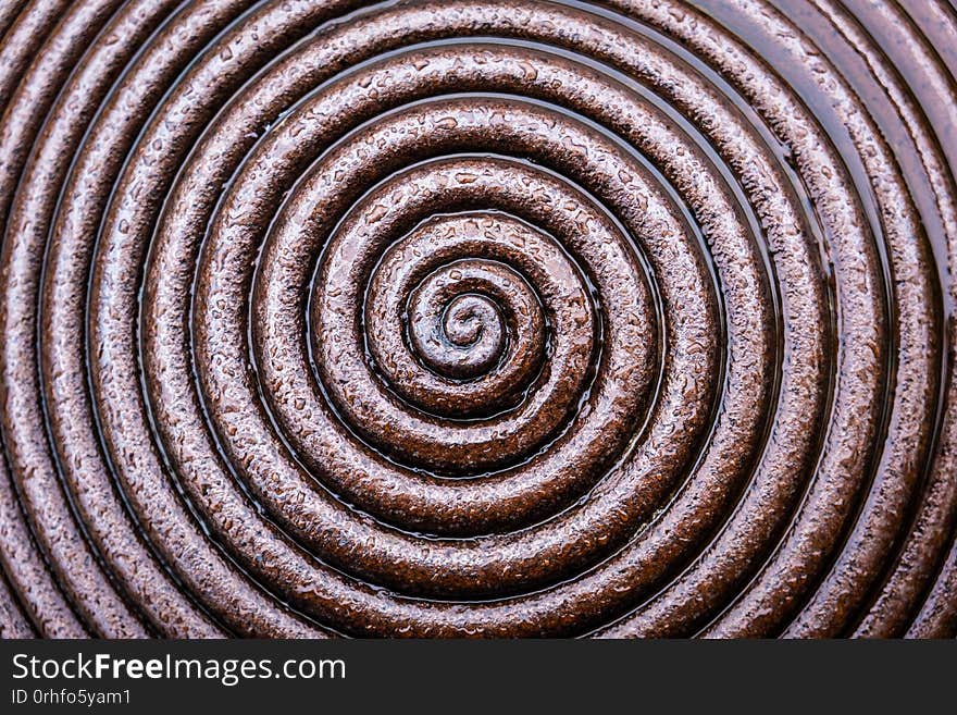 Wet metal spiral abstract background.