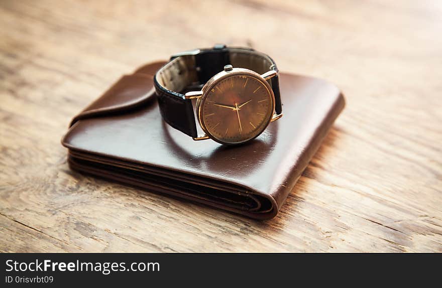 Wristwatch With Wallet On Wooden Background