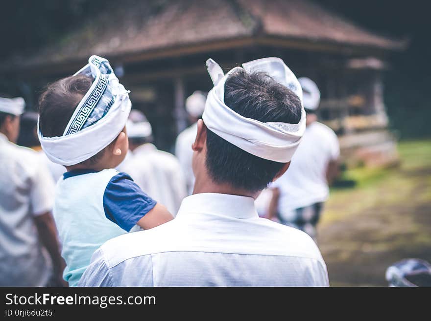 BALI, INDONESIA - JULY 4, 2018: Balinese children on a traditional ceremony. Baby with father.