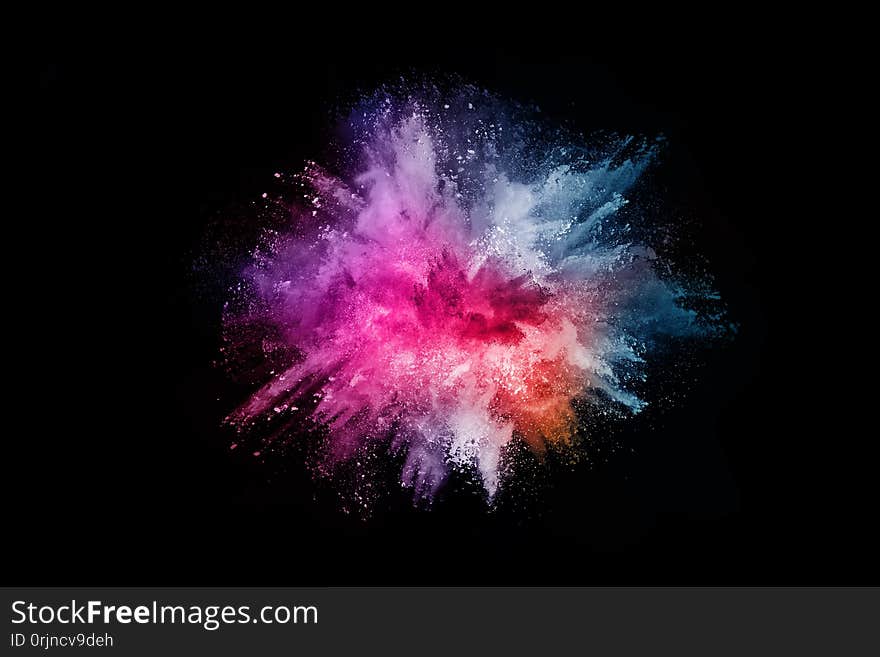 Abstract colored dust explosion on a black background.abstract powder splatted background,Freeze motion of color powder exploding/throwing color powder, multicolored glitter texture.
