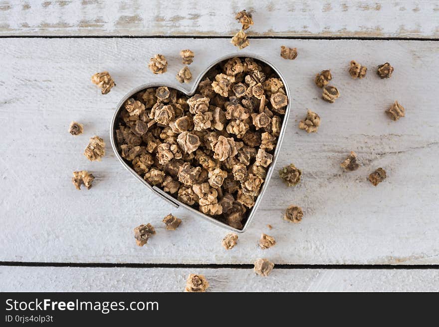 Close up view of beet seeds in a heart shape