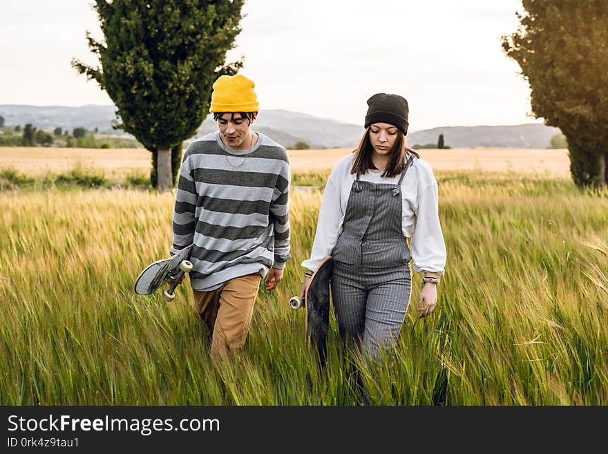 Young couple with casual style riding a skateboard. Millennial young lifestyle