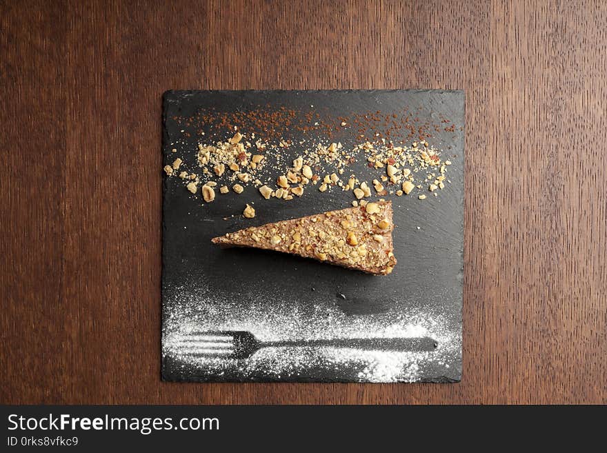 Chocolate cake with nuts on wooden table