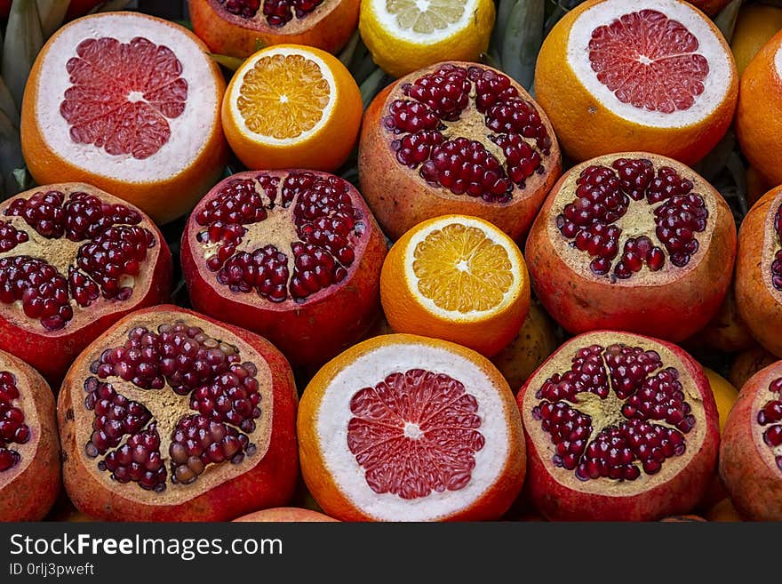 Many opened fruits at a market in Istanbul, Turkey during sunny day. Nice natural background with pomegranates, oranges and grape-fruits