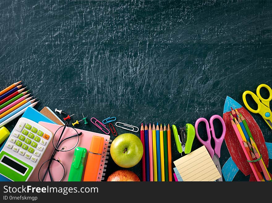 Education or back to school Concept. Top view of Colorful school supplies with books, color pencils, calculator, pen cutter clips