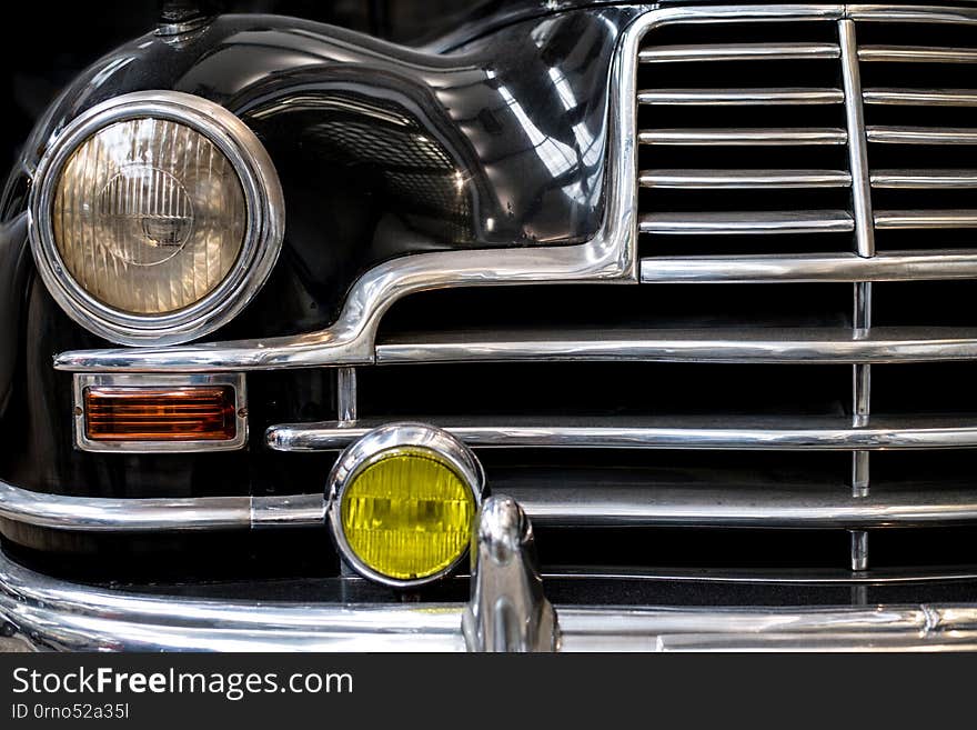 Detail on the headlight of a vintage car. Detail on the headlight of a vintage car