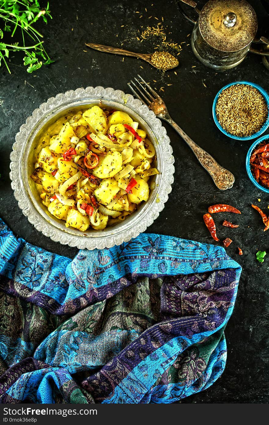 A set of photos showing a beautiful Indian dish - aloo masala, potato masala, or spiced potatoes. Served in an antique silver dish with spices. A set of photos showing a beautiful Indian dish - aloo masala, potato masala, or spiced potatoes. Served in an antique silver dish with spices.