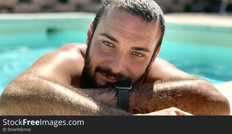 boy in the pool - pool in the background