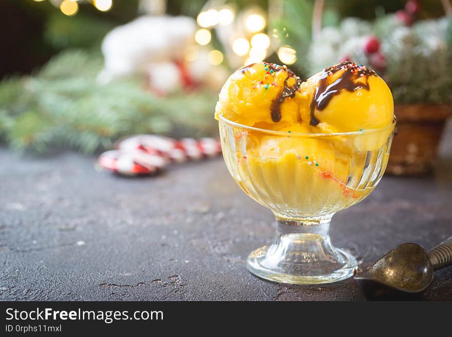 Glass bowl with delicious citrus ice cream on christmas background