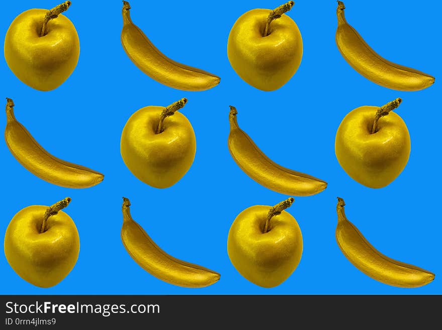 Collage of golden apples and bananas on the blue background. isolate