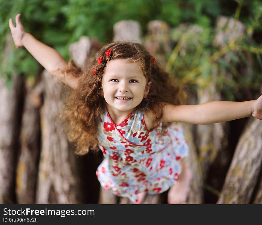 Little pretty girl in the green garden