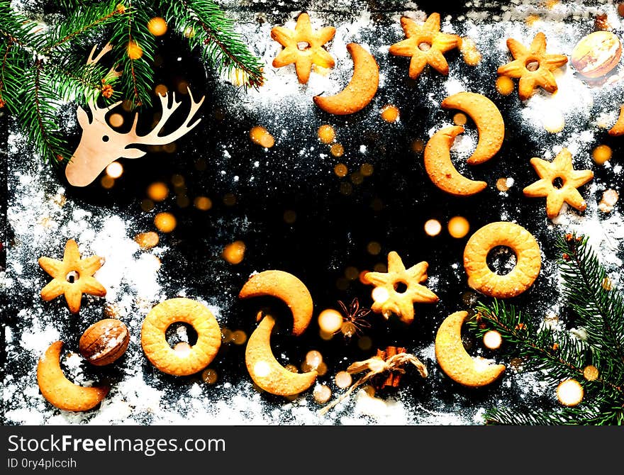 Christmas background. Festive cookies on black background. Blurred  effect. Close-up,copy space