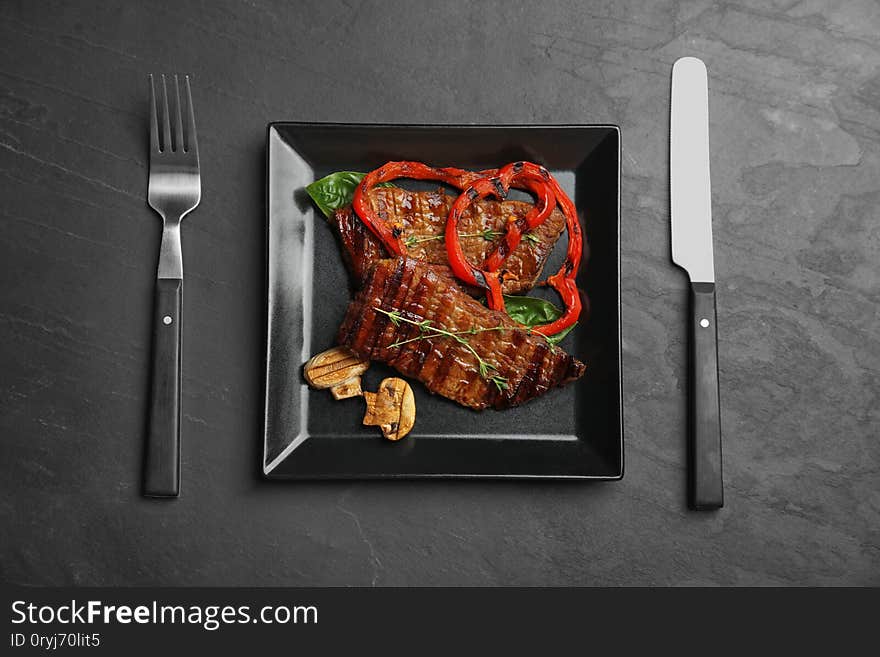 Flat lay composition with  meat on black table