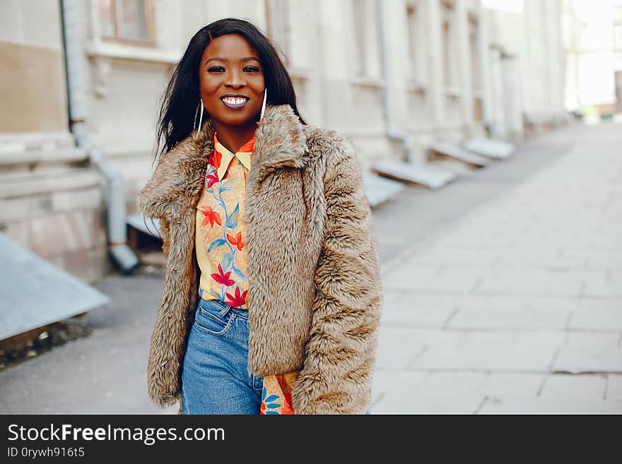 Stylish black girl in a city