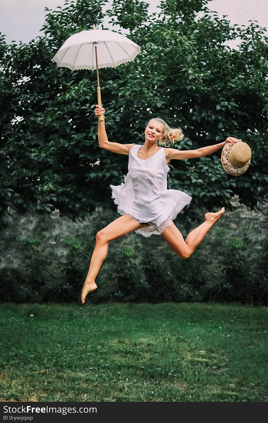 Woman jumping in a dance position in the nature