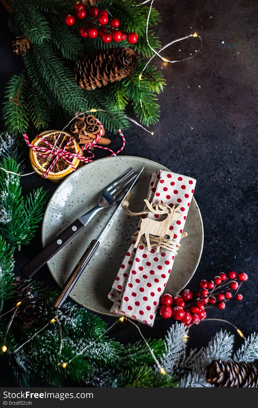 Table setting for festive holiday Christmas dinner on stone  background with copy space. Table setting for festive holiday Christmas dinner on stone  background with copy space