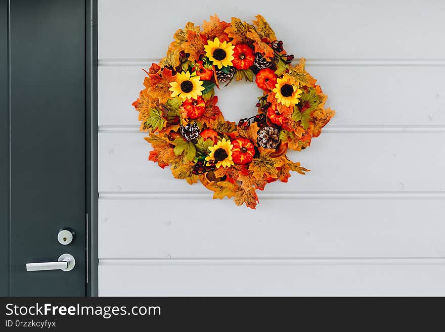 Thanksgiving Autumn wreath with sunflowers, pumpkins and maple leaves on front door