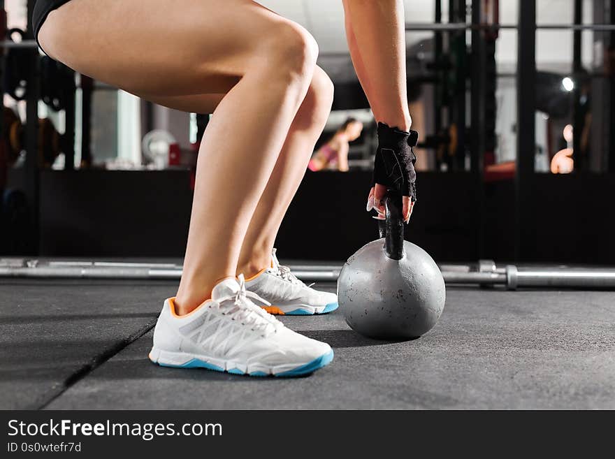 Woman with a kettlebell at the gym