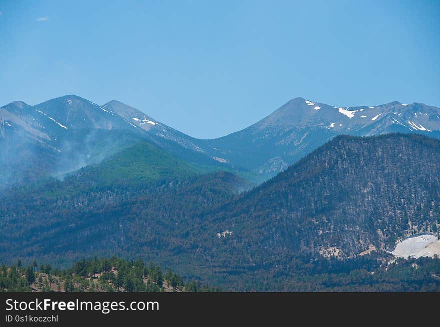 View from the road up Robinson Crater. A week after the Schultz Fire began, the wildfire is mostly contained. Clear skies and little smoke provided excellent visibility of the damage to the eastern face of the San Francisco Peaks.