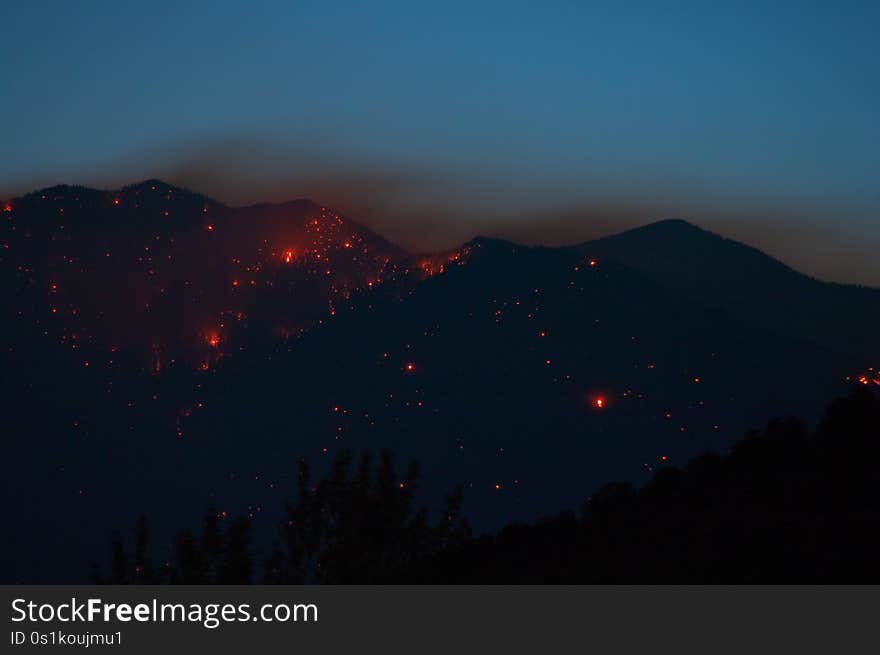 Day 2 of the Schultz Fire, Flagstaff, Arizona. Nighttime shots showing the flames visible on the side of the San Francisco Peaks. The northeastern flank appears to be alight all the way to the top.