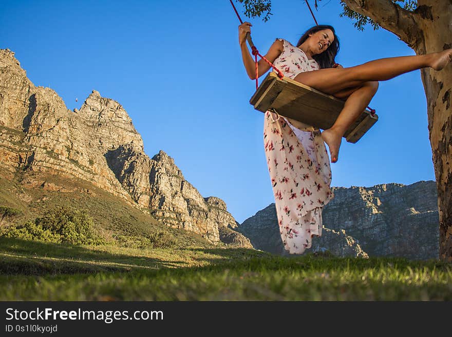 Beautiful Woman Swinging On A Swing In Nature With Table Mountain In The Background.