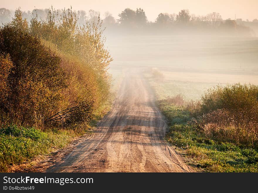 Autumnal foggy sunrise landscape