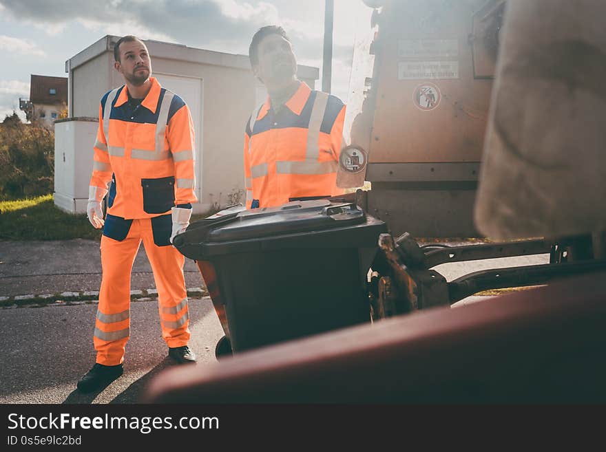 Garbage removal men working for a public utility