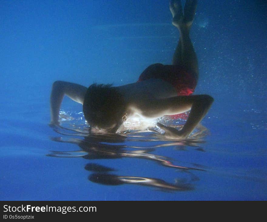 Beautiful shot of a kid swimming underwater