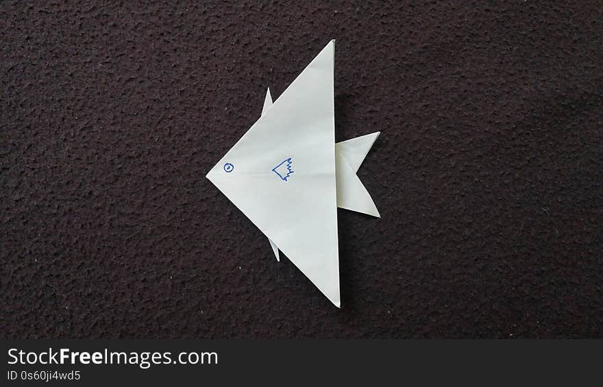 Top view of White fish origami drwan with face