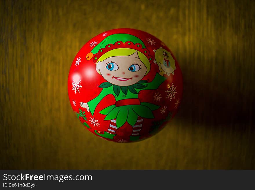 A closeup shot of an elf Christmas tree ornament on a wooden surface