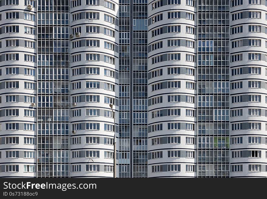 Close-up of high multiple dwelling building with wavy walls. Close-up of high multiple dwelling building with wavy walls