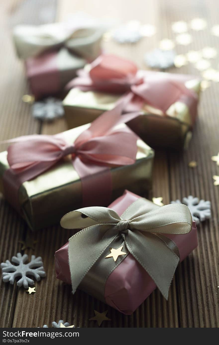 Beautiful golden gifts Christmas, party, birthday background. Celebrate shinny surprise boxes copy space wooden background