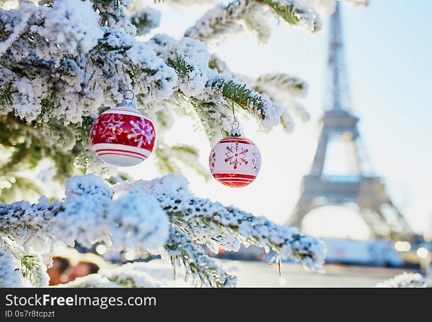 Christmas tree covered with snow near Eiffel tower