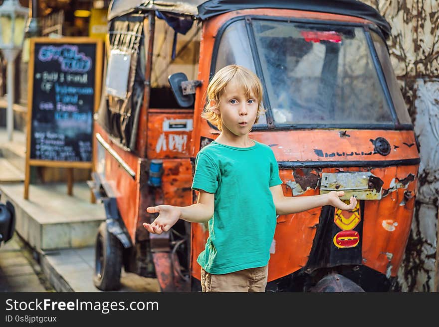 Boy at a market in Ubud, Bali. Typical souvenir shop selling souvenirs and handicrafts of Bali at the famous Ubud Market, Indonesia. Balinese market. Souvenirs of wood and crafts of local residents.